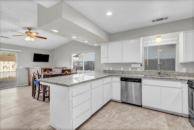 kitchen with light stone counters, kitchen peninsula, stainless steel appliances, white cabinets, and sink