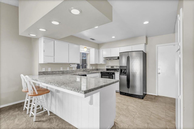 kitchen featuring stainless steel appliances, white cabinets, kitchen peninsula, light stone countertops, and a breakfast bar