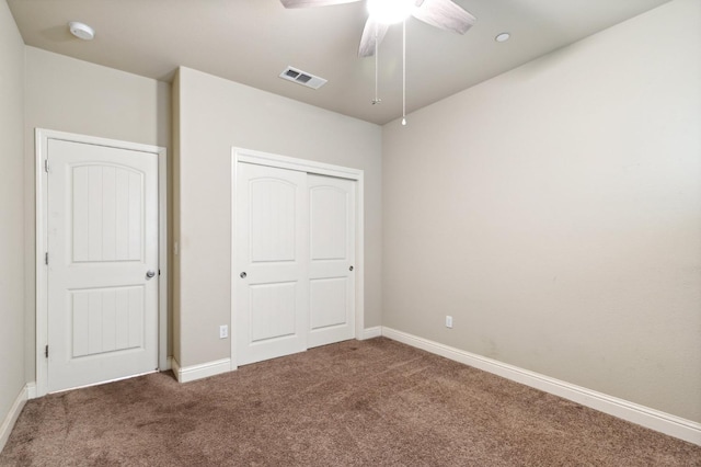 unfurnished bedroom featuring ceiling fan, a closet, and carpet