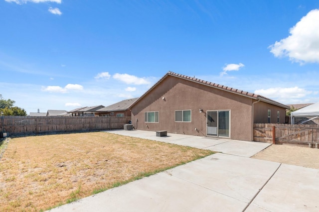 rear view of house featuring a patio and a lawn