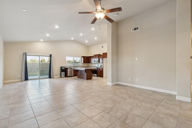 unfurnished living room with high vaulted ceiling, light tile patterned flooring, and ceiling fan