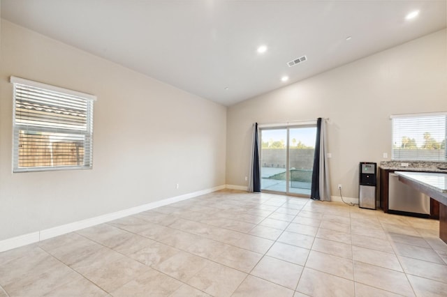 tiled spare room with lofted ceiling