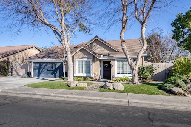 ranch-style house featuring a front lawn and a garage