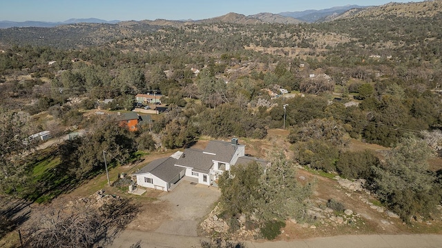 bird's eye view featuring a wooded view and a mountain view