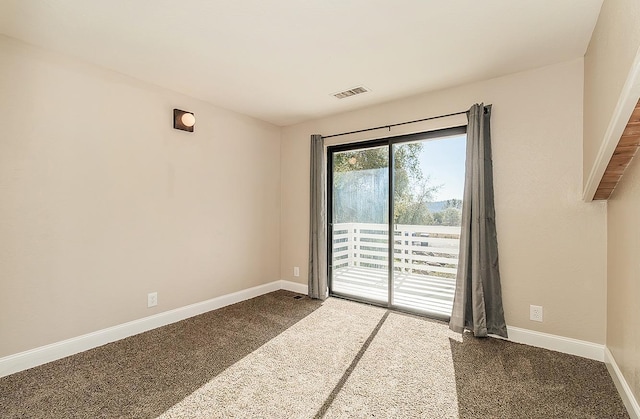 unfurnished room with carpet floors, baseboards, and visible vents