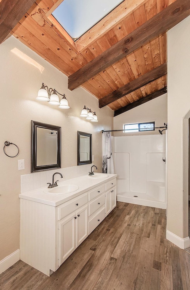 bathroom with curtained shower, wood ceiling, a sink, and wood finished floors