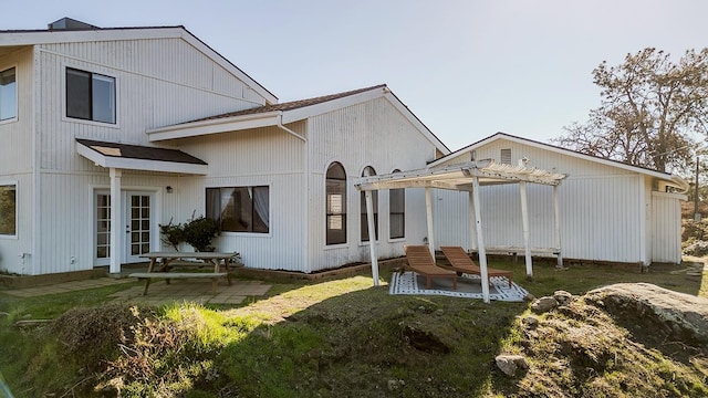 rear view of property with french doors, a pergola, and a patio