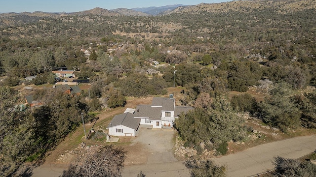 aerial view with a mountain view and a wooded view