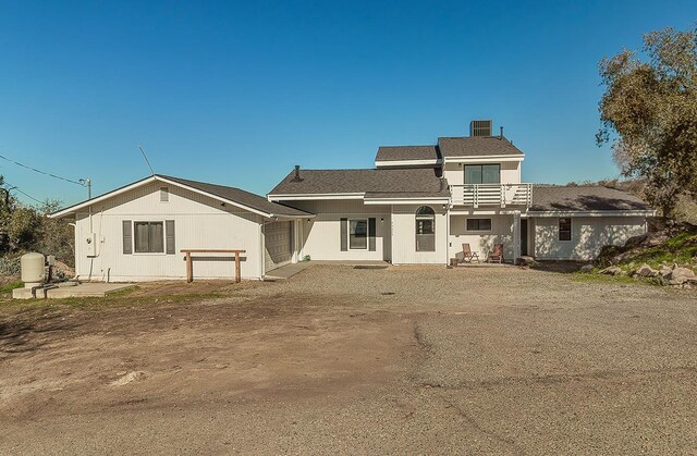 rear view of property with a garage