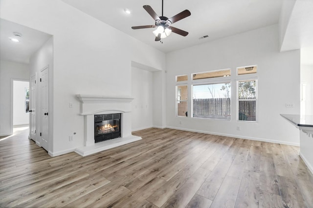 unfurnished living room with ceiling fan and light hardwood / wood-style floors