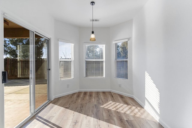 unfurnished dining area with light hardwood / wood-style floors