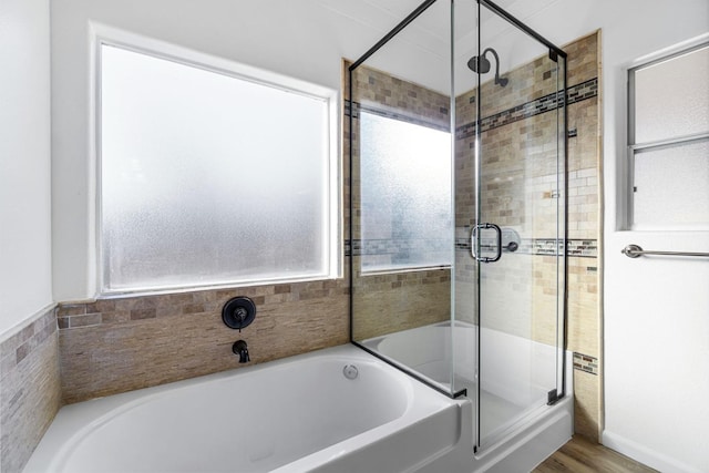 bathroom featuring wood-type flooring and independent shower and bath