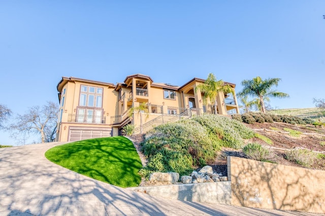 view of front of property with a balcony and a garage