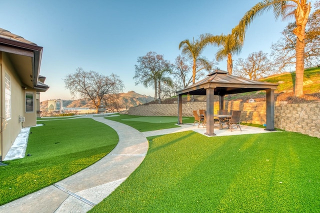 view of yard featuring a gazebo, a patio area, and a mountain view