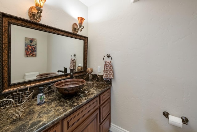 bathroom featuring toilet and vanity