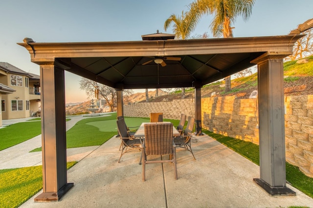 patio terrace at dusk with ceiling fan and a gazebo