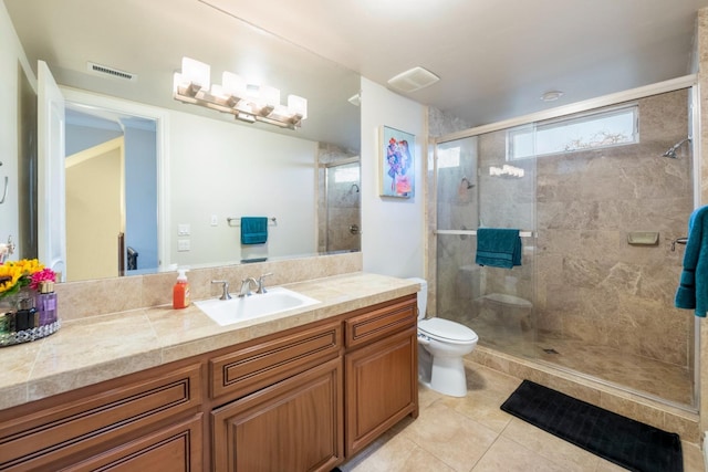 bathroom with a shower with shower door, tile patterned floors, vanity, and toilet