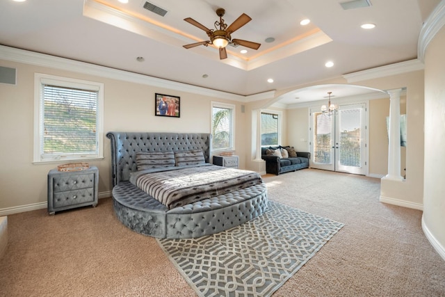 bedroom with decorative columns, carpet floors, a tray ceiling, access to outside, and ceiling fan with notable chandelier