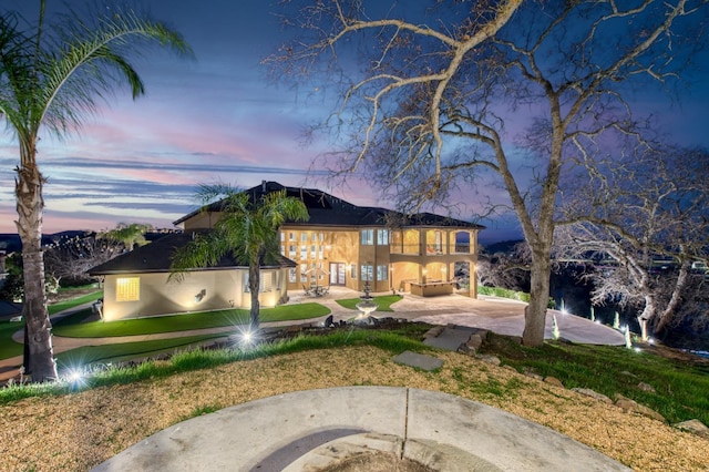 view of front of home with a balcony and a patio