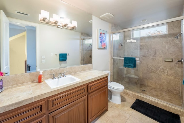 bathroom featuring a shower with shower door, tile patterned floors, toilet, and vanity