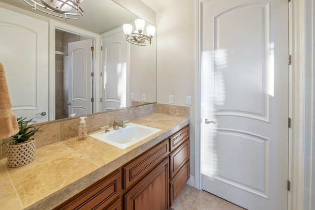 bathroom with a chandelier and vanity