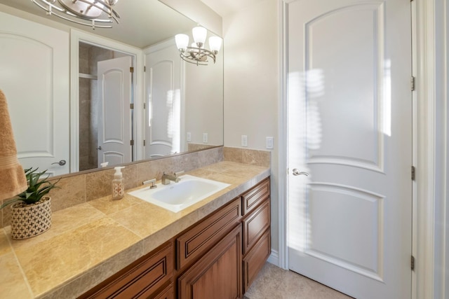 bathroom with vanity and a chandelier