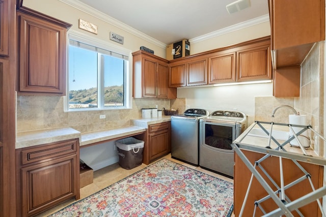 washroom featuring washer and clothes dryer, cabinets, sink, light tile patterned flooring, and crown molding