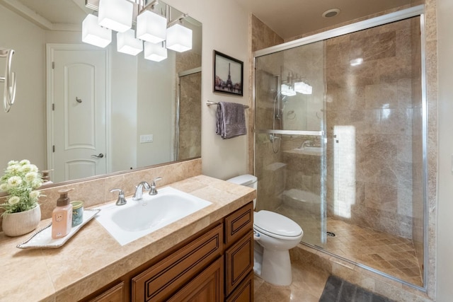 bathroom with toilet, an inviting chandelier, an enclosed shower, and vanity