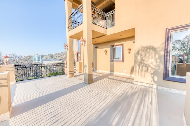 wooden terrace with a patio