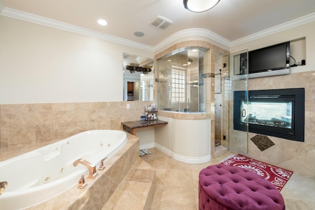 bathroom with plus walk in shower, crown molding, and a tiled fireplace