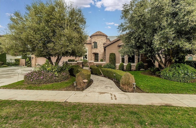 mediterranean / spanish house featuring a front yard