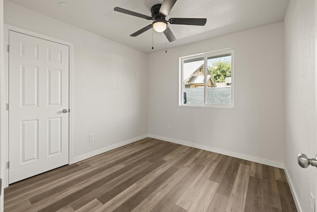 unfurnished room featuring ceiling fan and hardwood / wood-style flooring