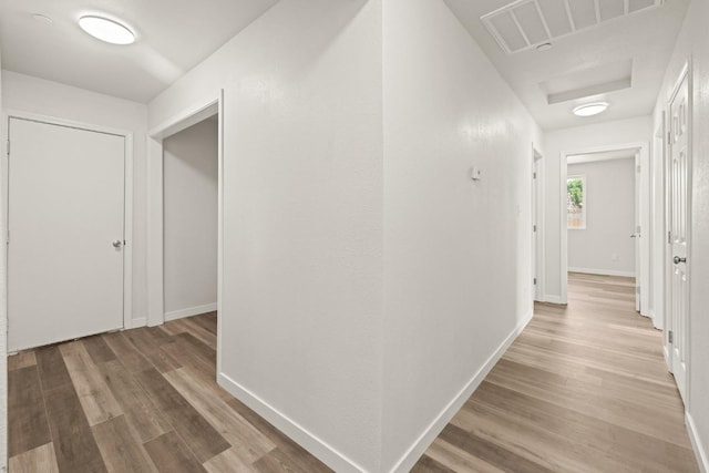 hall with hardwood / wood-style floors