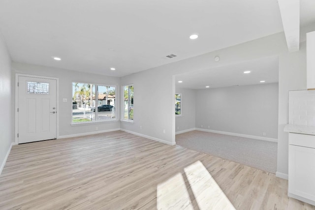 unfurnished living room featuring light hardwood / wood-style floors