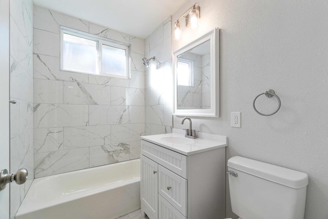 full bathroom with tiled shower / bath combo, vanity, and toilet