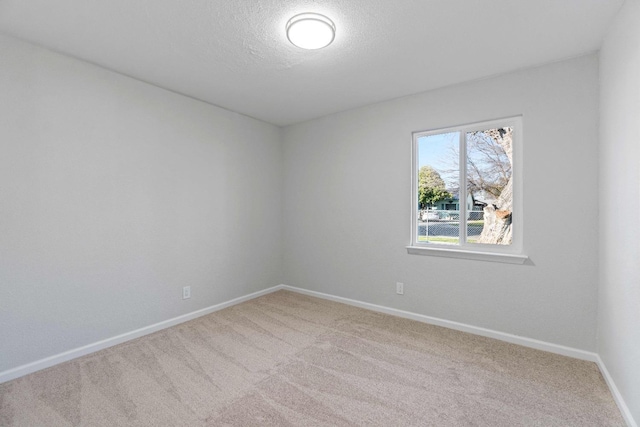 unfurnished room featuring a textured ceiling and carpet flooring