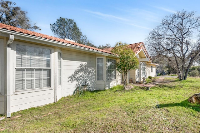 view of side of property with a lawn