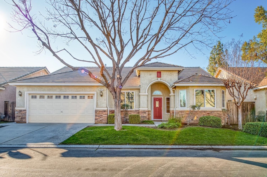 view of front of home with a front lawn and a garage