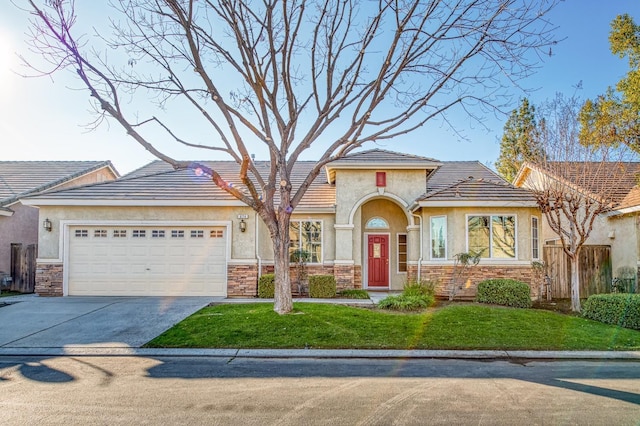 view of front of home with a front lawn and a garage