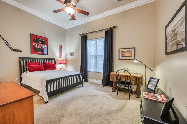 carpeted bedroom featuring ceiling fan and crown molding