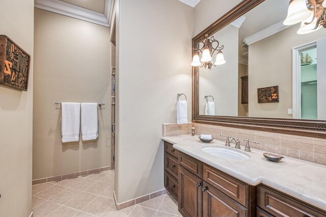 bathroom featuring ornamental molding, tile patterned floors, backsplash, and vanity