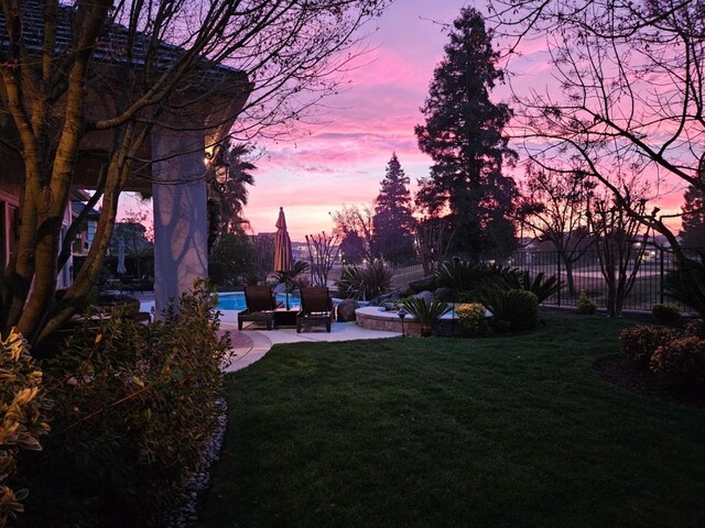 yard at dusk with a patio area