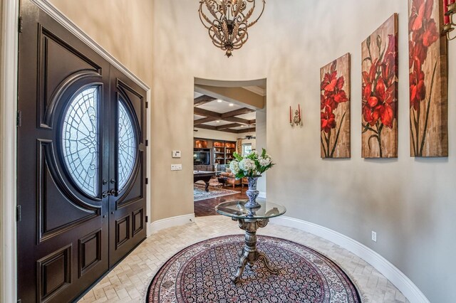 entryway with a wealth of natural light, beamed ceiling, and coffered ceiling