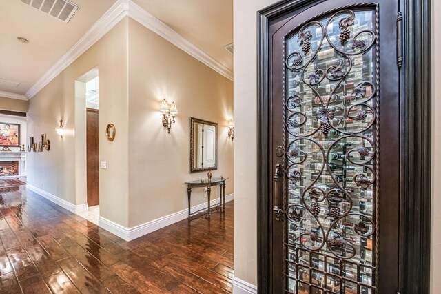 entryway featuring dark wood-type flooring and ornamental molding