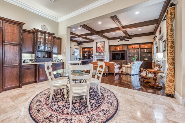 dining room with ceiling fan, beam ceiling, and coffered ceiling