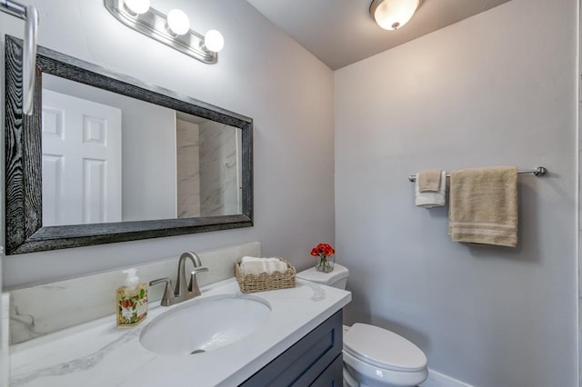 bathroom featuring toilet and vanity