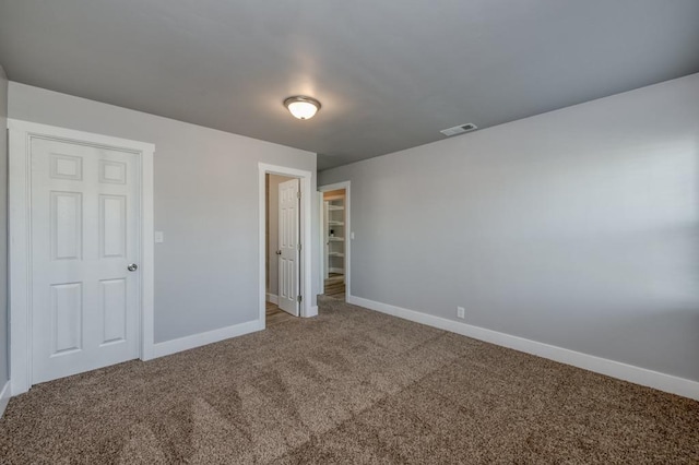 unfurnished bedroom featuring carpet floors and a closet