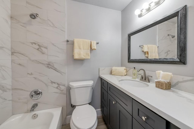 full bathroom with toilet, vanity, and tiled shower / bath