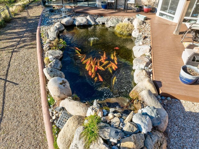 exterior details with a garden pond