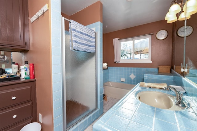 bathroom featuring vanity and separate shower and tub